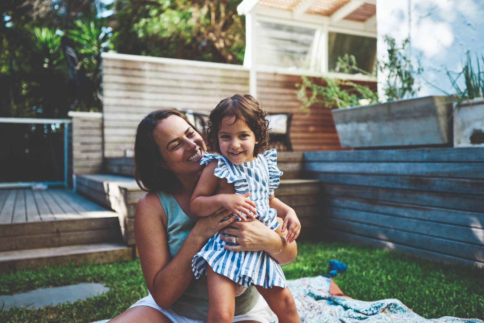 Woman with a prosthetic leg holding a baby.